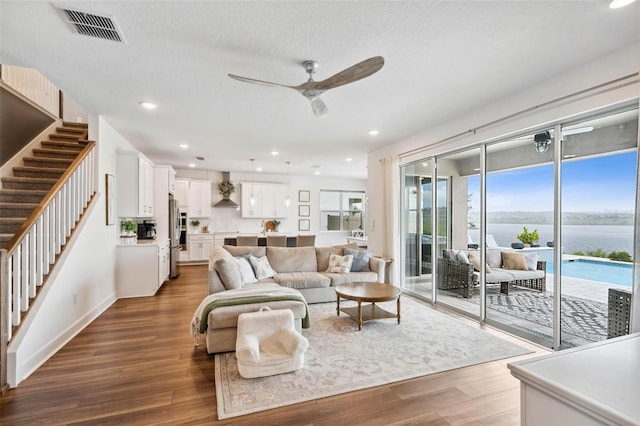 3304 Canna Lily Pl, Clermont, FL 34711 - living area featuring stairway, ceiling fan, wood finished floors, a water view, and recessed lighting