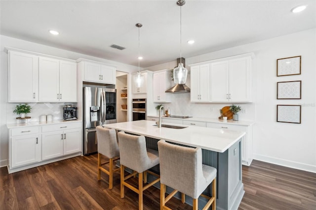 3304 Canna Lily Pl, Clermont, FL 34711 - kitchen featuring appliances with stainless steel finishes, tasteful backsplash, dark wood finished floors, and recessed lighting