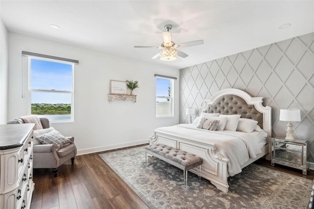 3304 Canna Lily Pl, Clermont, FL 34711 - bedroom featuring an accent wall, a ceiling fan, and dark wood finished floors