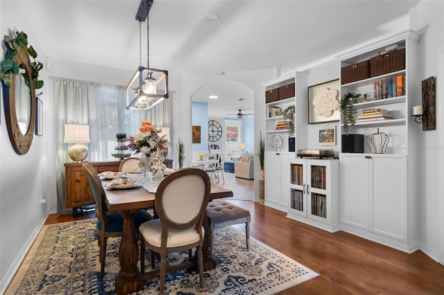 14708 Timucua Pl, Clermont, FL 34711 - dining area with wood finished floors, a ceiling fan, and arched walkways