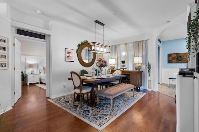 14708 Timucua Pl, Clermont, FL 34711 - dining space featuring arched walkways and dark wood-style floors