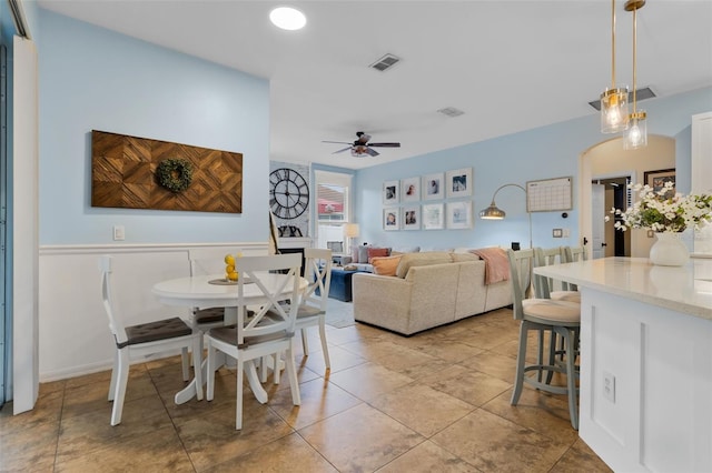 14708 Timucua Pl, Clermont, FL 34711 - dining space featuring ceiling fan, arched walkways, and light tile patterned floors