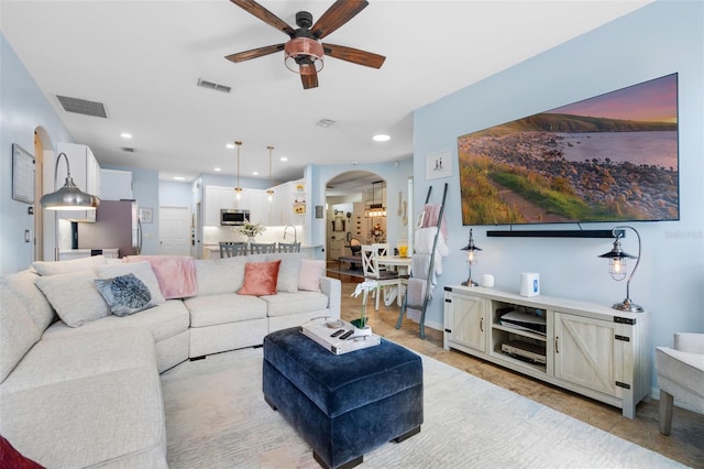 14708 Timucua Pl, Clermont, FL 34711 - living room featuring arched walkways, ceiling fan, and light tile patterned floors