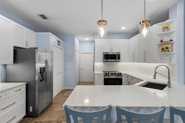 14708 Timucua Pl, Clermont, FL 34711 - kitchen featuring stainless steel appliances, tasteful backsplash, a peninsula, white cabinetry, and recessed lighting