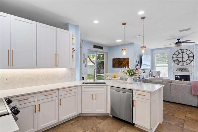 14708 Timucua Pl, Clermont, FL 34711 - kitchen with stainless steel dishwasher, a peninsula, open floor plan, white cabinets, and plenty of natural light