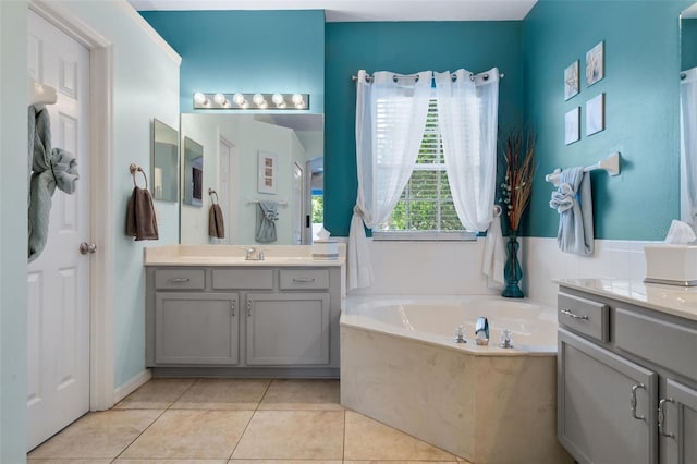 14708 Timucua Pl, Clermont, FL 34711 - bathroom with two vanities, a bath, and tile patterned floors