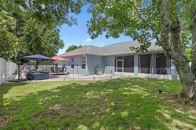14708 Timucua Pl, Clermont, FL 34711 - back of property featuring a fenced backyard, a hot tub, a patio, a sunroom, and roof with shingles