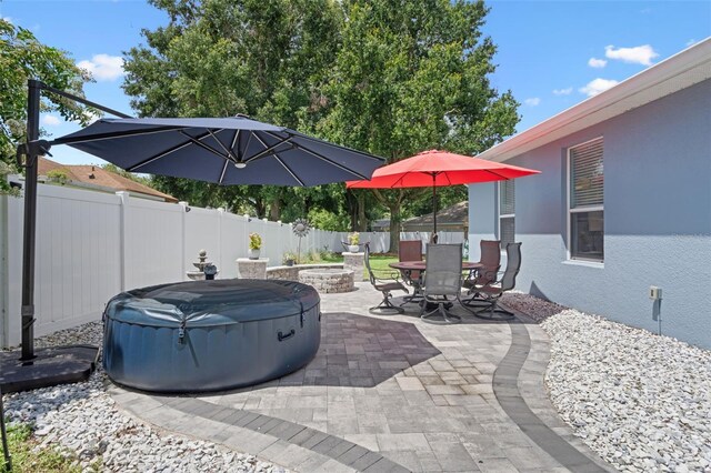 14708 Timucua Pl, Clermont, FL 34711 - fenced backyard featuring a patio area, outdoor dining space, and an outdoor fire pit
