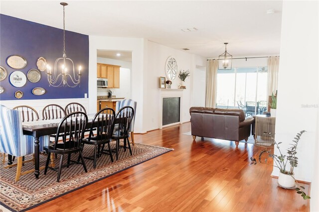 26620 Shoregrass Dr, Wesley Chapel, FL 33544 - dining area with a chandelier and light wood-type flooring