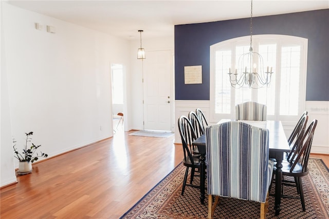 26620 Shoregrass Dr, Wesley Chapel, FL 33544 - dining area featuring a chandelier, wood finished floors, and arched walkways