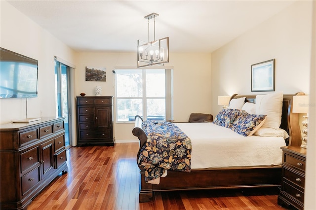 26620 Shoregrass Dr, Wesley Chapel, FL 33544 - bedroom with hardwood / wood-style flooring and a chandelier