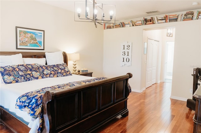 26620 Shoregrass Dr, Wesley Chapel, FL 33544 - bedroom featuring a chandelier and light wood-style floors