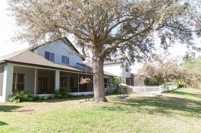 26620 Shoregrass Dr, Wesley Chapel, FL 33544 - back of house featuring a sunroom, stucco siding, and a shingled roof