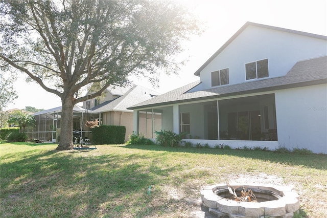 26620 Shoregrass Dr, Wesley Chapel, FL 33544 - view of green lawn with an outdoor fire pit and a sunroom