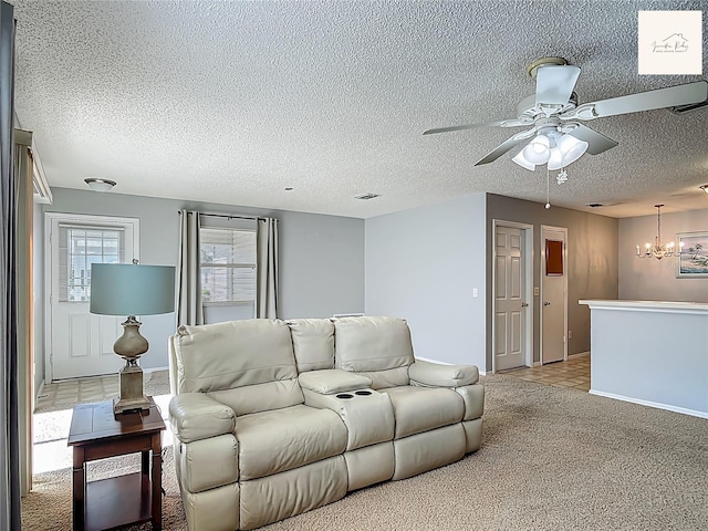2311 Pine Ridge St, The Villages, FL 32162 - living area with ceiling fan, a textured ceiling, a chandelier, carpet floors, and tile patterned flooring