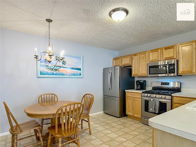2311 Pine Ridge St, The Villages, FL 32162 - kitchen featuring stainless steel appliances, a chandelier, light countertops, a textured ceiling, and light brown cabinetry