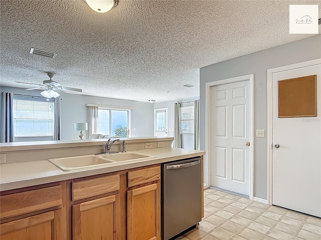 2311 Pine Ridge St, The Villages, FL 32162 - kitchen featuring stainless steel dishwasher, a textured ceiling, light countertops, and a ceiling fan