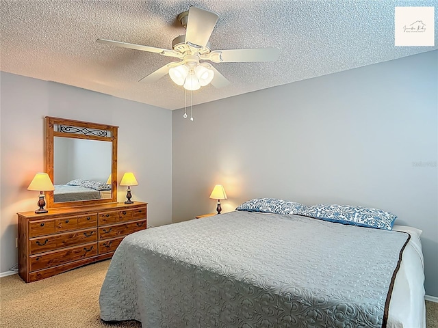2311 Pine Ridge St, The Villages, FL 32162 - bedroom with light carpet, a textured ceiling, and ceiling fan