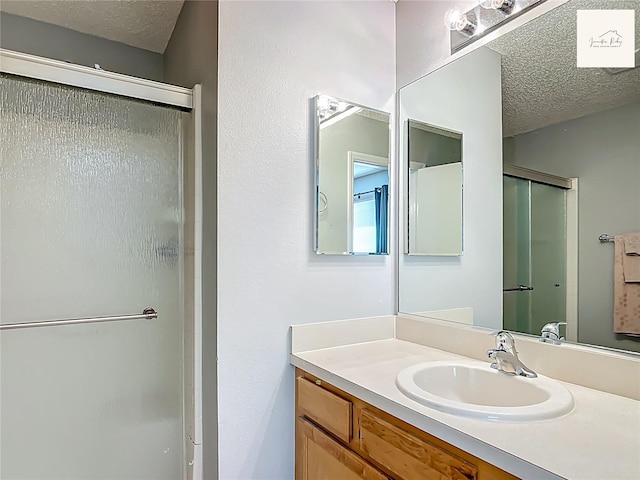 2311 Pine Ridge St, The Villages, FL 32162 - full bath with a shower stall, a textured ceiling, and vanity