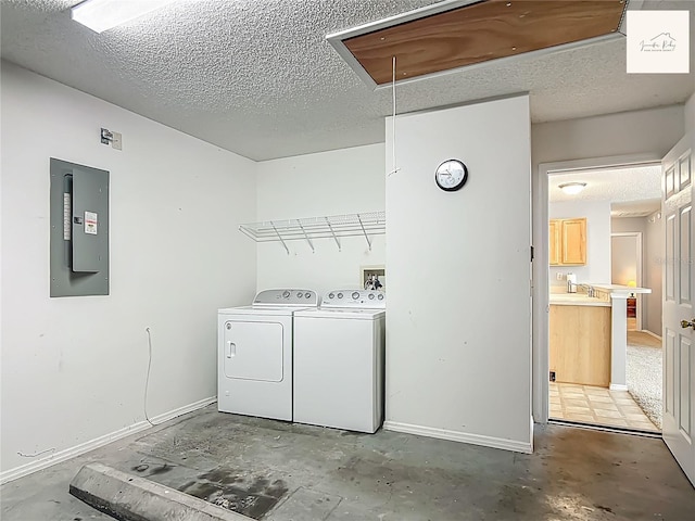 2311 Pine Ridge St, The Villages, FL 32162 - washroom featuring attic access, electric panel, washer and dryer, and a textured ceiling