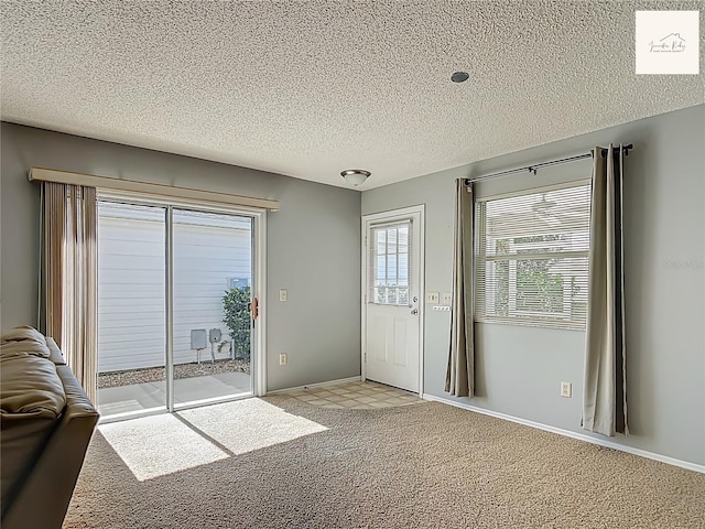 2311 Pine Ridge St, The Villages, FL 32162 - doorway featuring light colored carpet and a textured ceiling