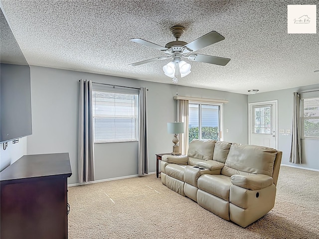 2311 Pine Ridge St, The Villages, FL 32162 - living room with light carpet, a ceiling fan, and a textured ceiling