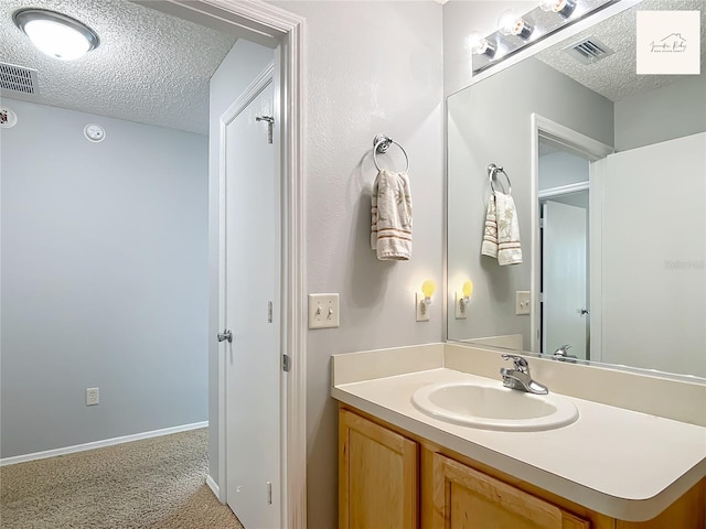 2311 Pine Ridge St, The Villages, FL 32162 - bathroom with a textured ceiling and vanity