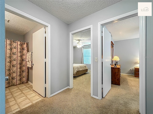 2311 Pine Ridge St, The Villages, FL 32162 - hallway with a textured ceiling and light carpet