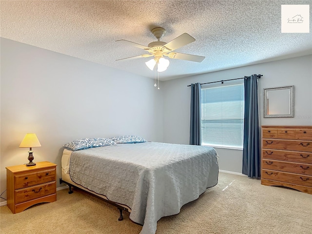 2311 Pine Ridge St, The Villages, FL 32162 - bedroom featuring light colored carpet, a ceiling fan, and a textured ceiling