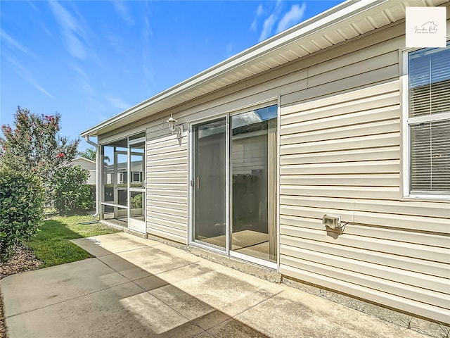 2311 Pine Ridge St, The Villages, FL 32162 - view of side of property featuring a patio area and a sunroom