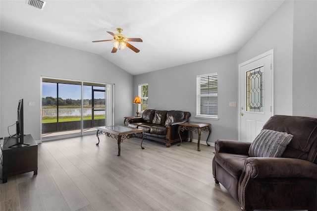 5715 Illumination Ln, Leesburg, FL 34748 - living room with vaulted ceiling, healthy amount of natural light, a ceiling fan, and light wood finished floors