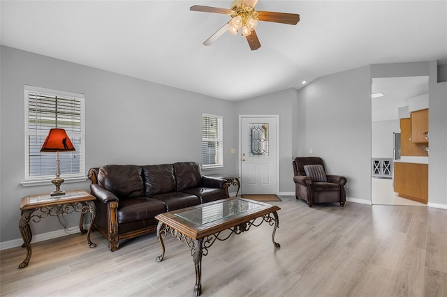5715 Illumination Ln, Leesburg, FL 34748 - living room featuring vaulted ceiling, a ceiling fan, and light wood-style floors