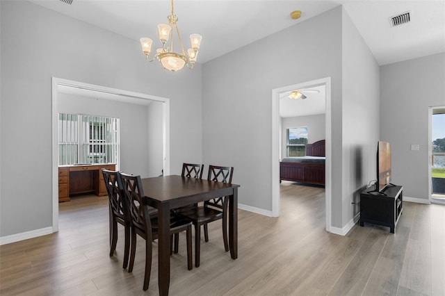 5715 Illumination Ln, Leesburg, FL 34748 - dining area featuring light wood-style flooring, healthy amount of natural light, and a chandelier