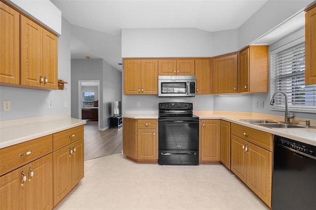 5715 Illumination Ln, Leesburg, FL 34748 - kitchen featuring black appliances, light countertops, and brown cabinets