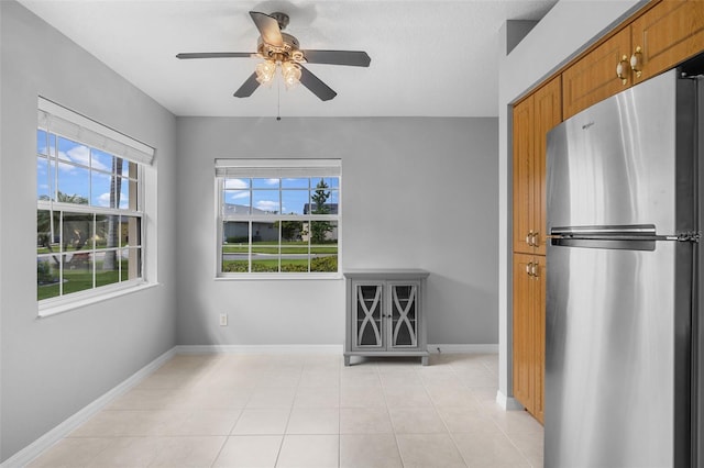 5715 Illumination Ln, Leesburg, FL 34748 - unfurnished dining area featuring ceiling fan and light tile patterned floors