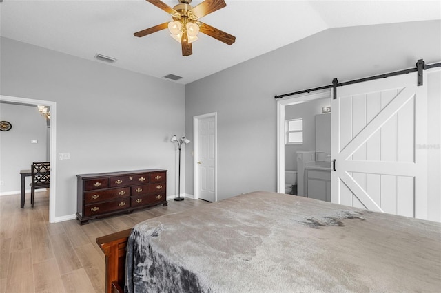 5715 Illumination Ln, Leesburg, FL 34748 - bedroom featuring wood finished floors, a barn door, lofted ceiling, and ceiling fan