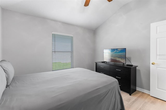 5715 Illumination Ln, Leesburg, FL 34748 - bedroom featuring light wood-style floors, lofted ceiling, and a ceiling fan