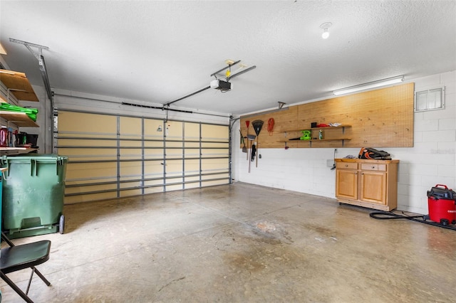 5715 Illumination Ln, Leesburg, FL 34748 - garage featuring a garage door opener and concrete block wall