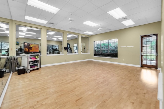 5715 Illumination Ln, Leesburg, FL 34748 - workout area with light wood-type flooring, plenty of natural light, and a drop ceiling