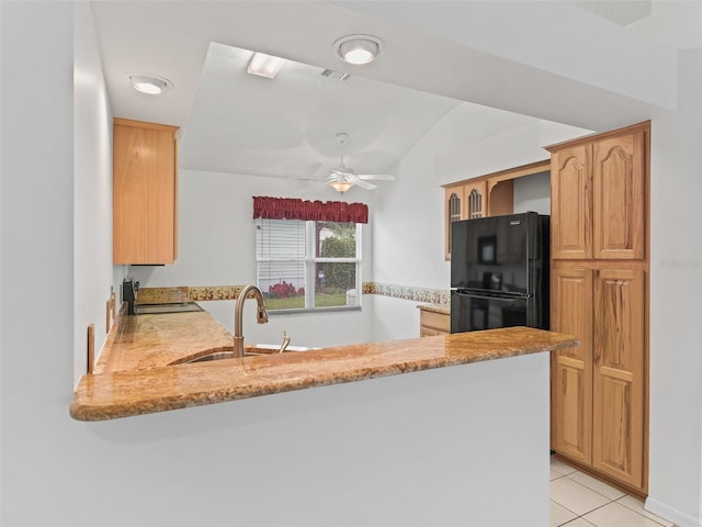 1142 W Boone Ct, The Villages, FL 32159 - kitchen with freestanding refrigerator, a peninsula, a ceiling fan, vaulted ceiling, and light tile patterned floors