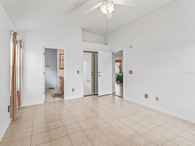1142 W Boone Ct, The Villages, FL 32159 - unfurnished bedroom with vaulted ceiling, light tile patterned floors, connected bathroom, and ceiling fan
