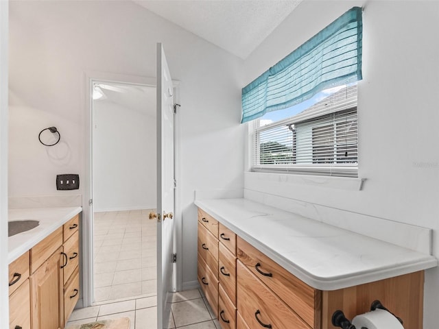 1142 W Boone Ct, The Villages, FL 32159 - bathroom featuring vanity, tile patterned floors, and a textured ceiling