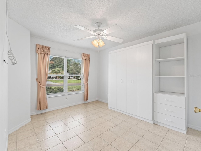 1142 W Boone Ct, The Villages, FL 32159 - unfurnished bedroom with a textured ceiling, ceiling fan, a closet, and light tile patterned floors