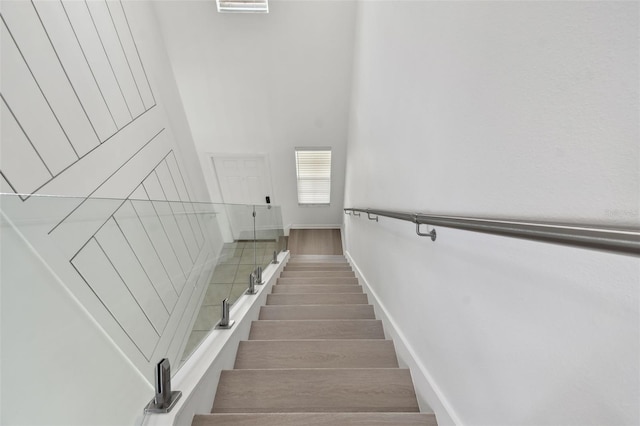 2139 Stellar Brilliance Way, Lutz, FL 33558 - stairway featuring a high ceiling and wood finished floors