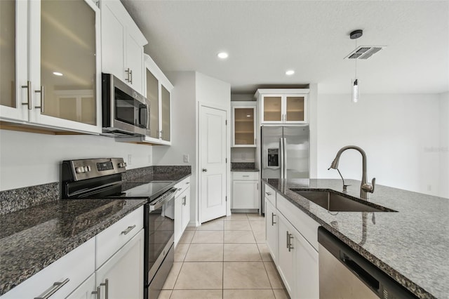 2139 Stellar Brilliance Way, Lutz, FL 33558 - kitchen featuring stainless steel appliances, pendant lighting, white cabinets, glass insert cabinets, and recessed lighting