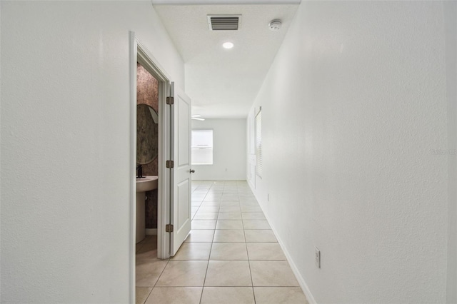 2139 Stellar Brilliance Way, Lutz, FL 33558 - corridor featuring light tile patterned floors and baseboards