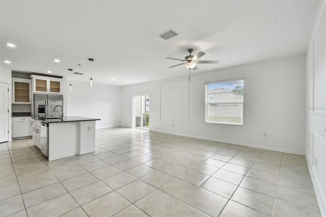 2139 Stellar Brilliance Way, Lutz, FL 33558 - kitchen featuring dark countertops, stainless steel refrigerator with ice dispenser, open floor plan, recessed lighting, and light tile patterned flooring