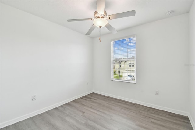 2139 Stellar Brilliance Way, Lutz, FL 33558 - empty room with wood finished floors, a smoke detector, and ceiling fan