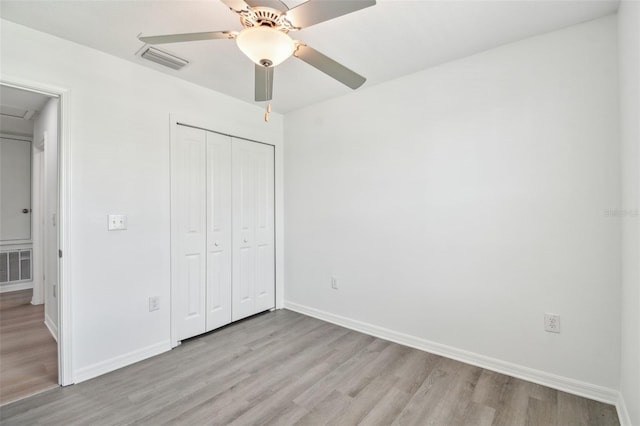 2139 Stellar Brilliance Way, Lutz, FL 33558 - unfurnished bedroom featuring light wood finished floors, a closet, and a ceiling fan