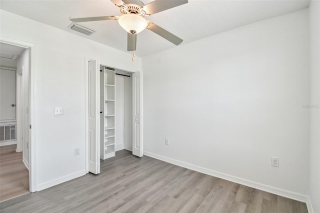 2139 Stellar Brilliance Way, Lutz, FL 33558 - unfurnished bedroom with light wood finished floors, ceiling fan, and a closet